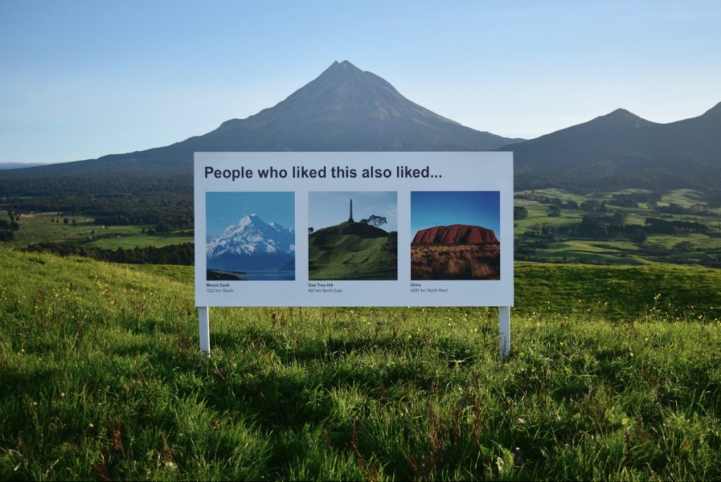 A sign at a mountain scene says “People who liked this also liked,” which is followed by photographs of other scenic landscapes. Satirical art installation by Scott Kelly and Ben Polkinghome.